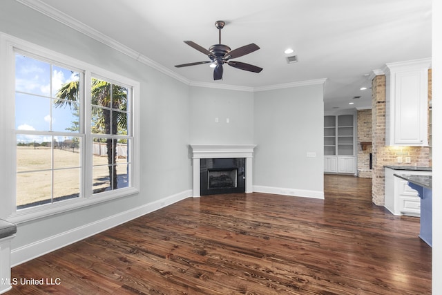 unfurnished living room with crown molding, built in features, dark hardwood / wood-style floors, and ceiling fan