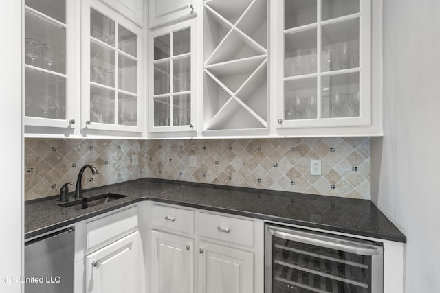 bar featuring dishwashing machine, sink, white cabinetry, decorative backsplash, and beverage cooler