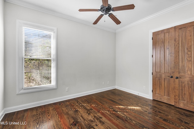 empty room featuring crown molding, dark hardwood / wood-style floors, and ceiling fan