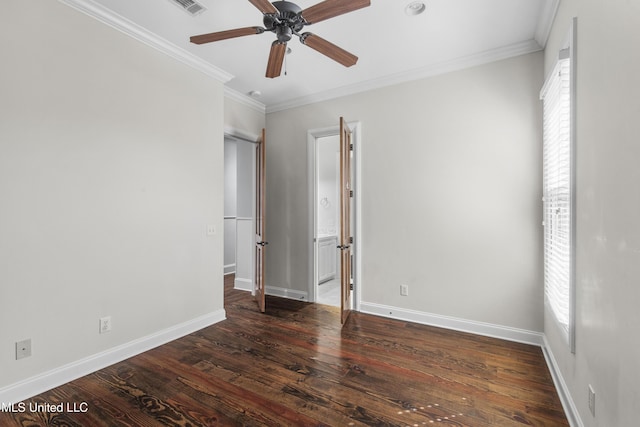 spare room with crown molding, a wealth of natural light, and dark wood-type flooring