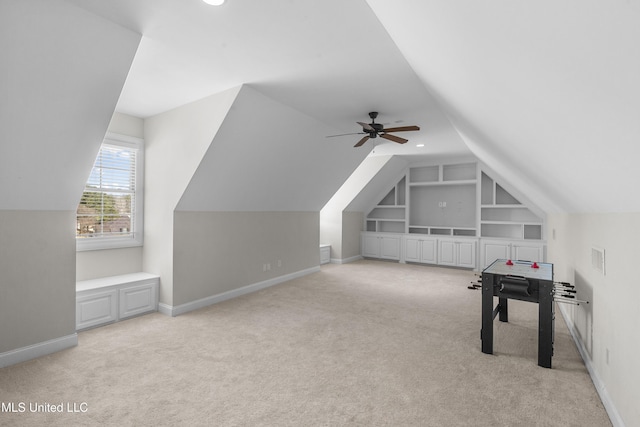 playroom with light carpet, built in shelves, and ceiling fan