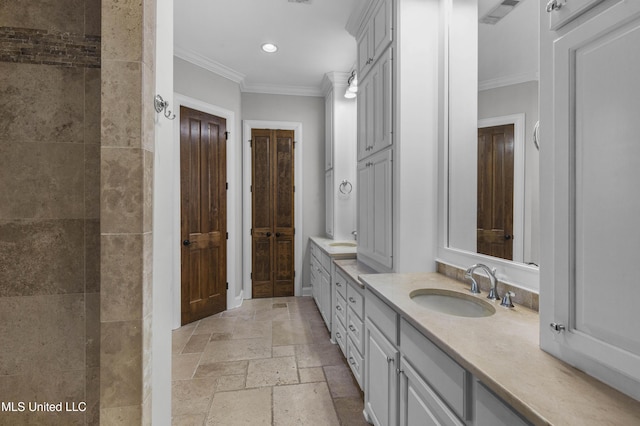 bathroom with ornamental molding and vanity