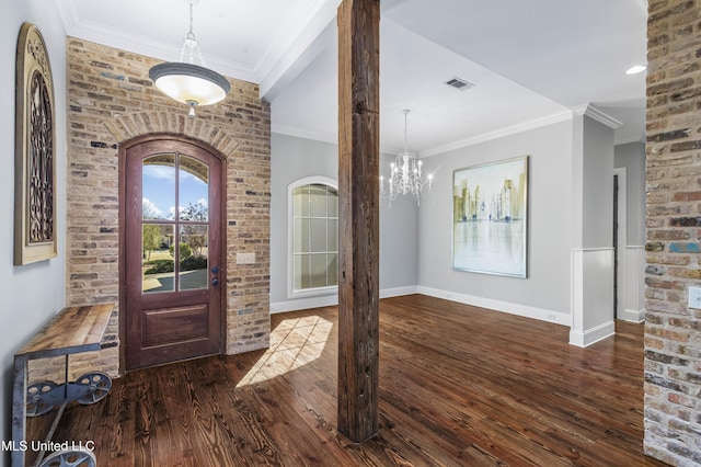 entryway featuring crown molding, a notable chandelier, and dark hardwood / wood-style flooring