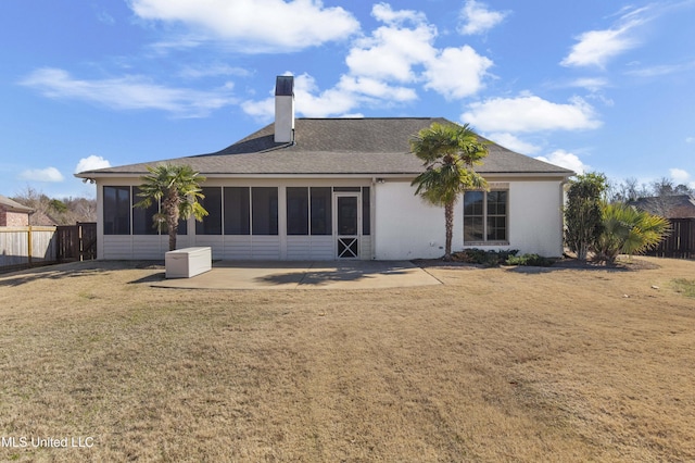 back of property featuring a patio, a sunroom, and a yard