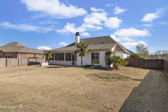 back of property featuring a lawn