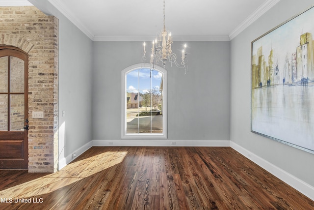 unfurnished dining area featuring hardwood / wood-style flooring, ornamental molding, and an inviting chandelier