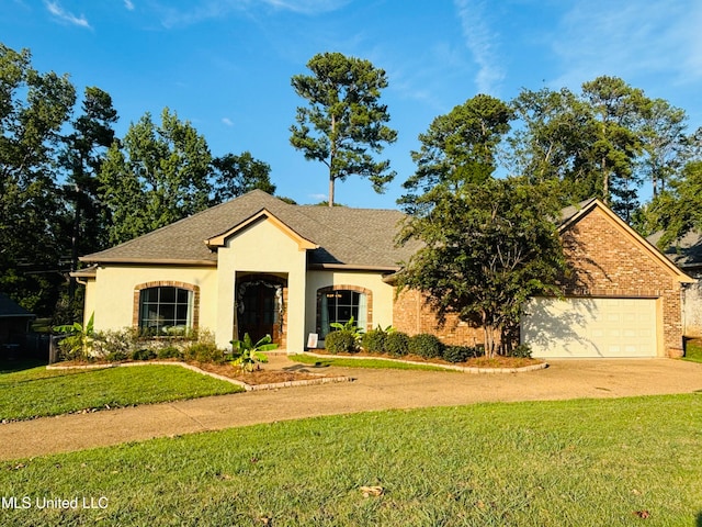 view of front of home with a front lawn and a garage