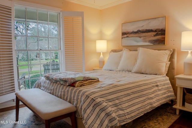 bedroom featuring multiple windows, crown molding, and wood finished floors