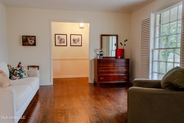 sitting room featuring baseboards, dark wood finished floors, and crown molding