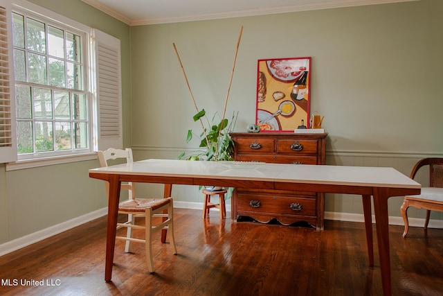 dining room featuring ornamental molding, a wainscoted wall, and dark wood finished floors