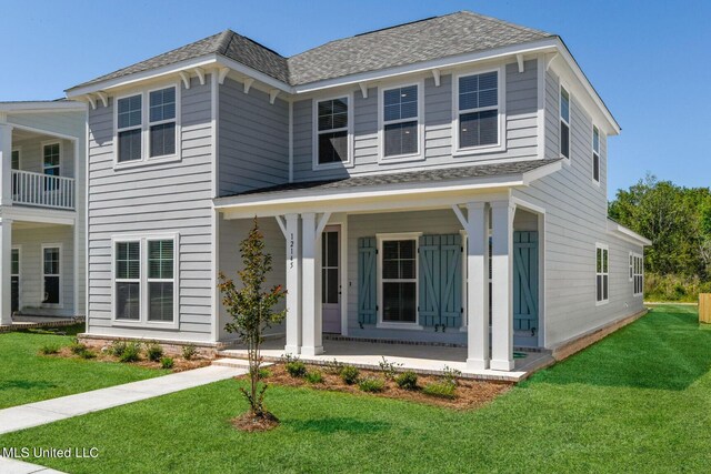 12105 Creole Way, Gulfport, MS 39503 - view of front of property with a porch, a shingled roof, and a front lawn