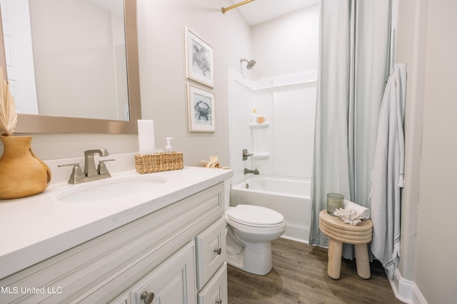 full bathroom with toilet, hardwood / wood-style floors, shower / tub combo with curtain, and vanity