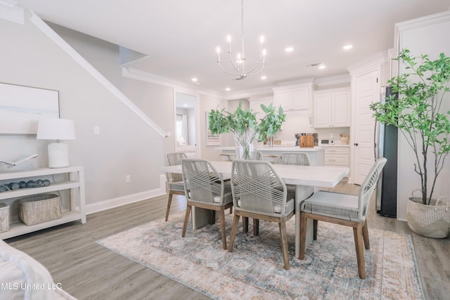 12105 Creole Way, Gulfport, MS 39503 - dining space with a chandelier, light wood-style flooring, baseboards, recessed lighting, and ornamental molding