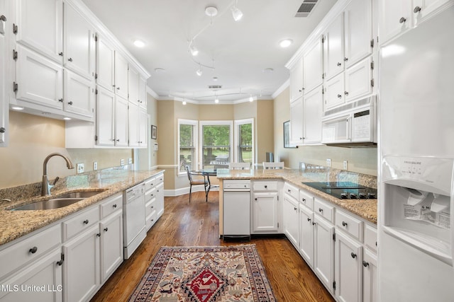 kitchen featuring white appliances, a sink, white cabinets, and crown molding