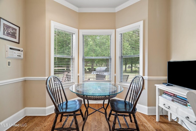 dining area with baseboards, wood finished floors, and ornamental molding