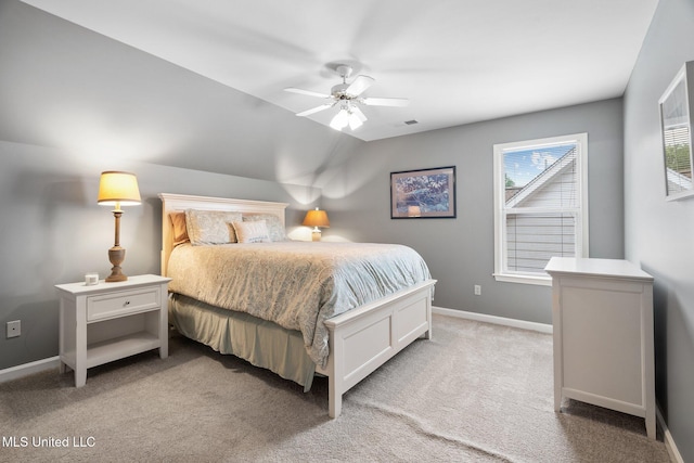 bedroom with light carpet, baseboards, lofted ceiling, and a ceiling fan