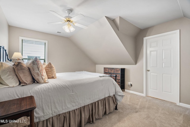 carpeted bedroom featuring lofted ceiling, baseboards, and a ceiling fan