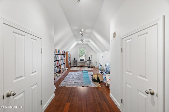 additional living space with wood finished floors, ceiling fan, vaulted ceiling, and baseboards
