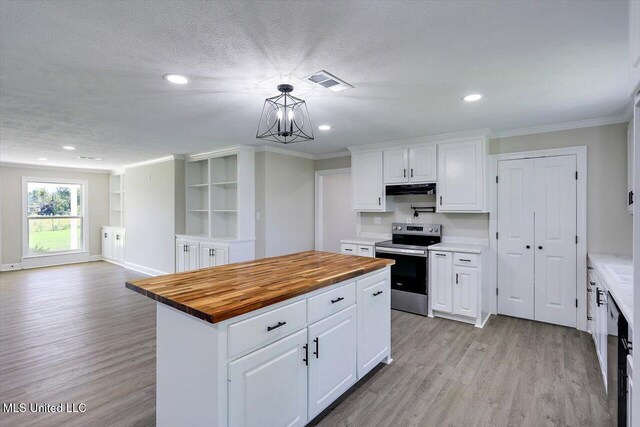 kitchen with butcher block counters, a center island, stainless steel appliances, light hardwood / wood-style flooring, and white cabinets