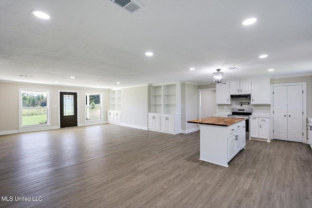 kitchen featuring stainless steel electric range oven, wood-type flooring, a center island, white cabinetry, and butcher block counters