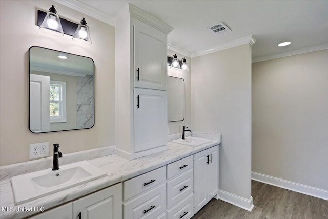 bathroom with hardwood / wood-style floors, vanity, and ornamental molding