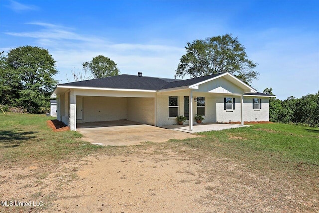 back of property with a lawn and a carport