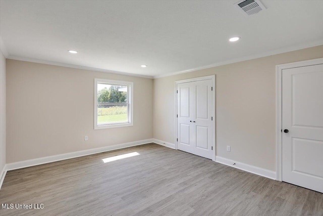 unfurnished bedroom featuring light hardwood / wood-style flooring and ornamental molding