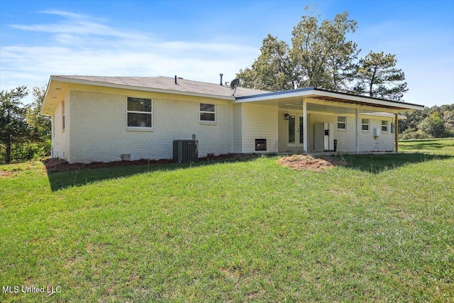 back of property featuring a lawn and central AC unit