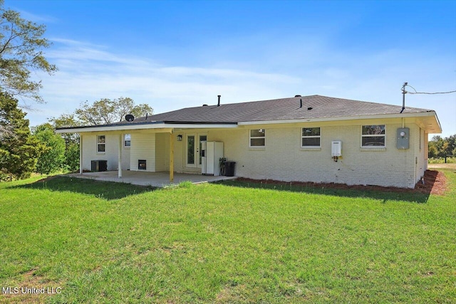 back of property featuring central air condition unit, a patio area, and a yard