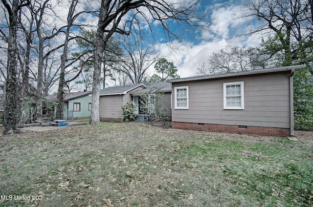 back of property featuring a yard