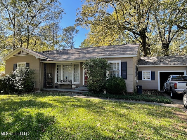 single story home featuring a front yard, a garage, and covered porch