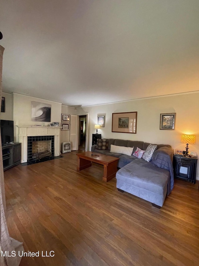 living room featuring a tile fireplace and hardwood / wood-style floors