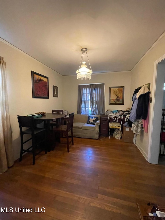 dining room featuring a chandelier, dark hardwood / wood-style floors, and ornamental molding