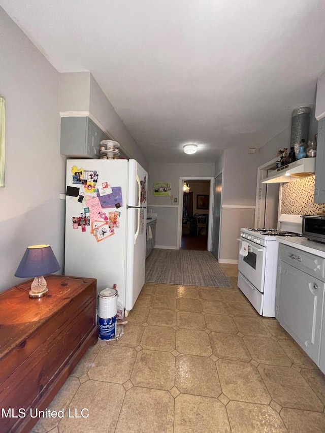 kitchen featuring white appliances, extractor fan, and gray cabinetry