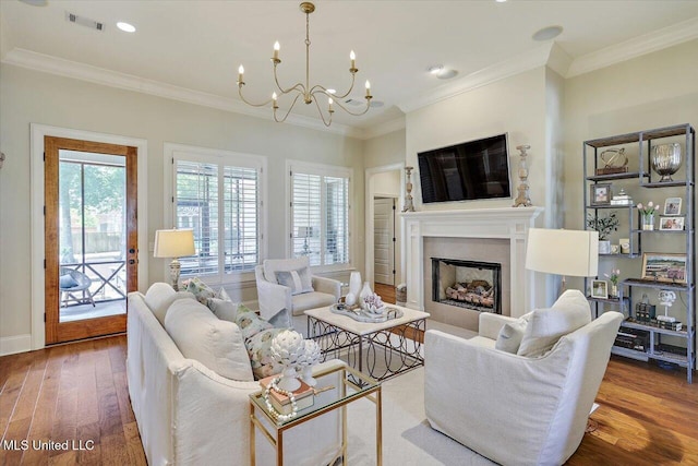 215 Grayhawk Dr, Madison, MS 39110 - living area featuring wood finished floors, a fireplace, a chandelier, ornamental molding, and recessed lighting