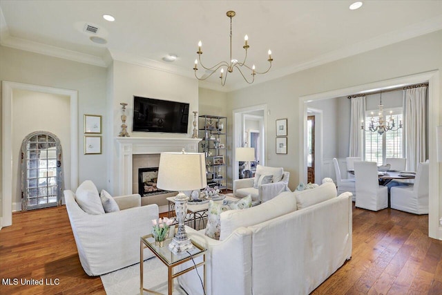 215 Grayhawk Dr, Madison, MS 39110 - living area featuring a chandelier, ornamental molding, wood finished floors, a fireplace, and recessed lighting