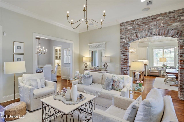 215 Grayhawk Dr, Madison, MS 39110 - living area featuring a chandelier, wood finished floors, ornamental molding, and arched walkways