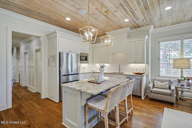 215 Grayhawk Dr, Madison, MS 39110 - kitchen with appliances with stainless steel finishes, crown molding, dark wood-type flooring, a chandelier, and decorative backsplash