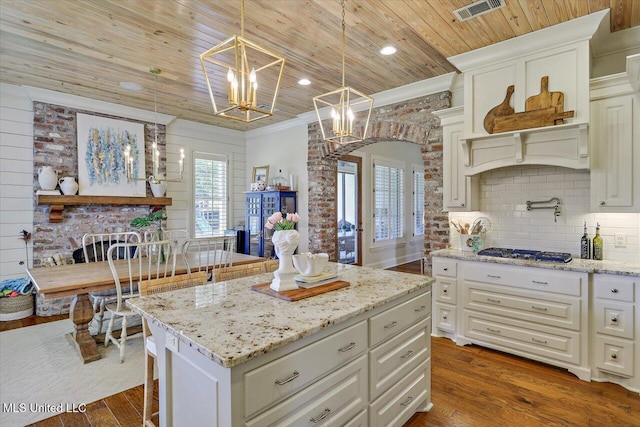215 Grayhawk Dr, Madison, MS 39110 - kitchen with wooden ceiling, stainless steel gas cooktop, a chandelier, dark wood-type flooring, and light stone countertops