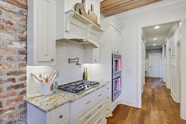 215 Grayhawk Dr, Madison, MS 39110 - kitchen with appliances with stainless steel finishes, dark wood finished floors, white cabinets, tasteful backsplash, and light stone counters
