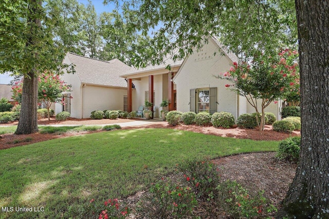 215 Grayhawk Dr, Madison, MS 39110 - view of front facade featuring a front lawn, stucco siding, and roof with shingles