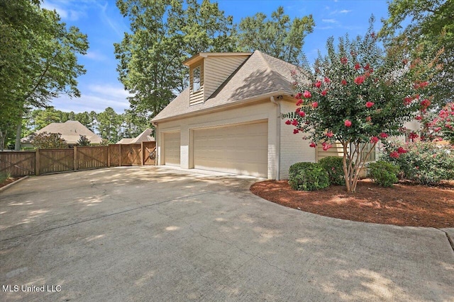 215 Grayhawk Dr, Madison, MS 39110 - view of home's exterior featuring brick siding, driveway, a shingled roof, and a garage