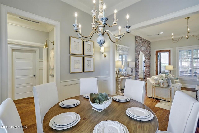 215 Grayhawk Dr, Madison, MS 39110 - dining area with a chandelier, wood finished floors, and crown molding