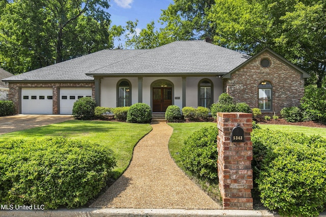 single story home featuring a front yard and a garage