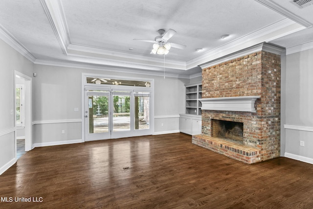 unfurnished living room with dark hardwood / wood-style flooring, crown molding, a fireplace, and ceiling fan