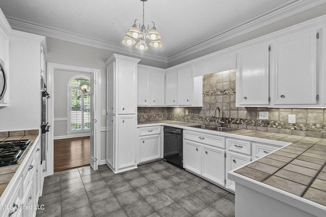 kitchen featuring black dishwasher, sink, tile countertops, hanging light fixtures, and white cabinets