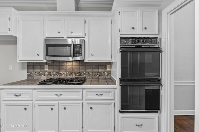 kitchen with white cabinetry, black double oven, and backsplash