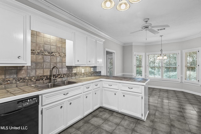 kitchen featuring sink, dishwasher, tile countertops, pendant lighting, and white cabinets