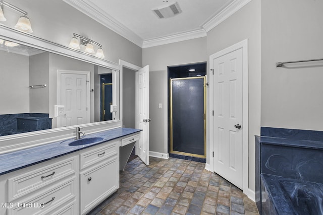 bathroom with vanity, ornamental molding, and walk in shower