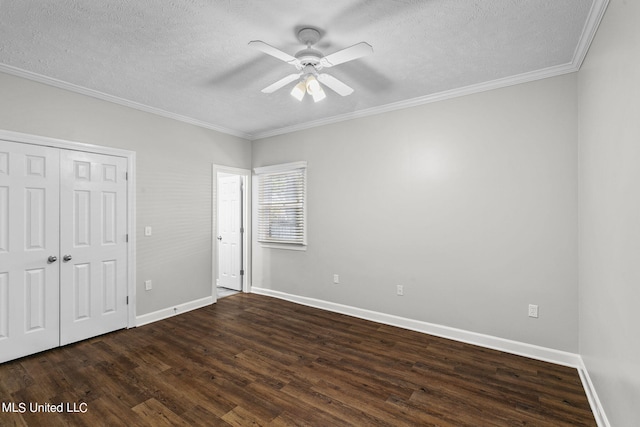 unfurnished bedroom with dark wood-type flooring, crown molding, a textured ceiling, and ceiling fan